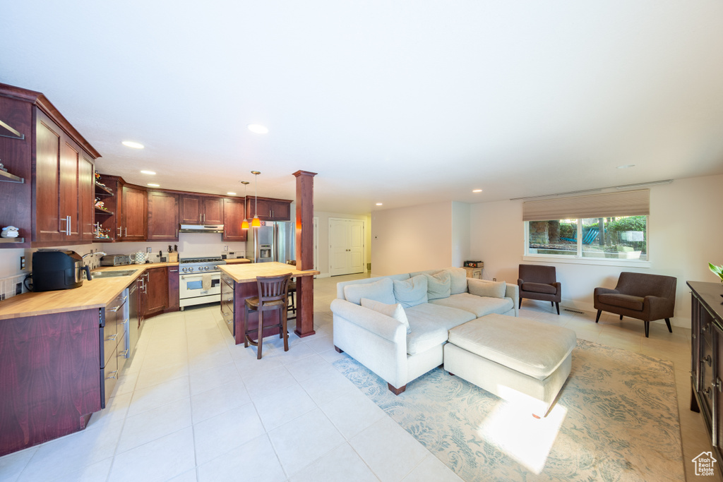 Living area featuring recessed lighting and light tile patterned flooring