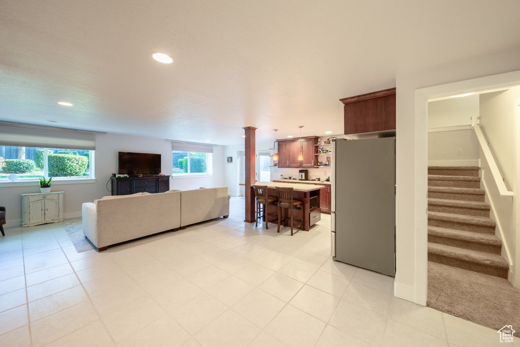 Living area with recessed lighting, baseboards, stairs, and a wealth of natural light