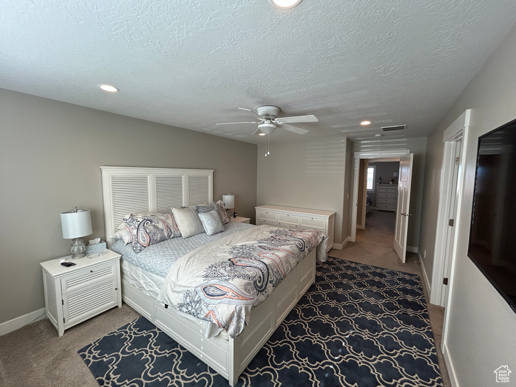 Bedroom with carpet floors, recessed lighting, a textured ceiling, and baseboards