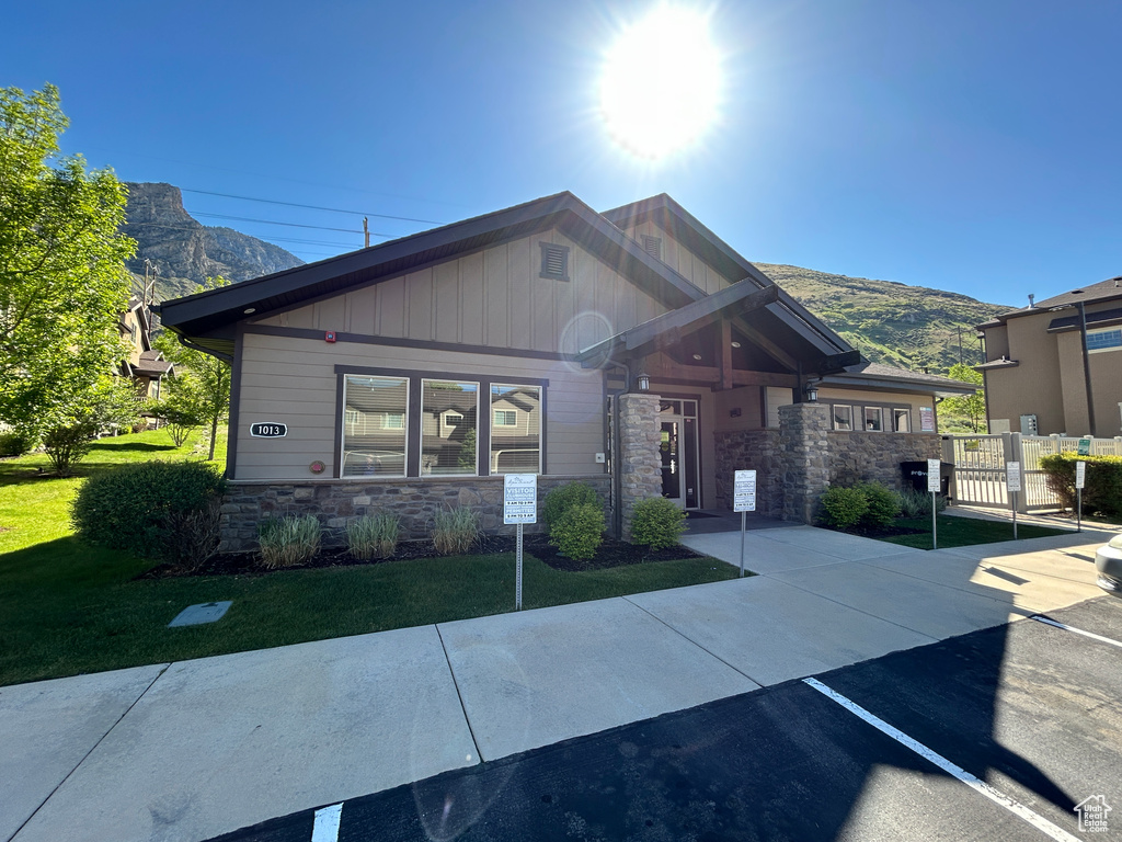 View of front facade featuring fence, a gate, a mountain view, and stone siding