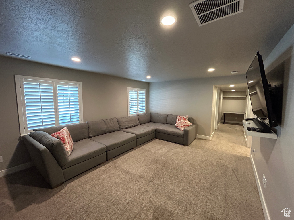 Living area with visible vents, recessed lighting, baseboards, and carpet floors