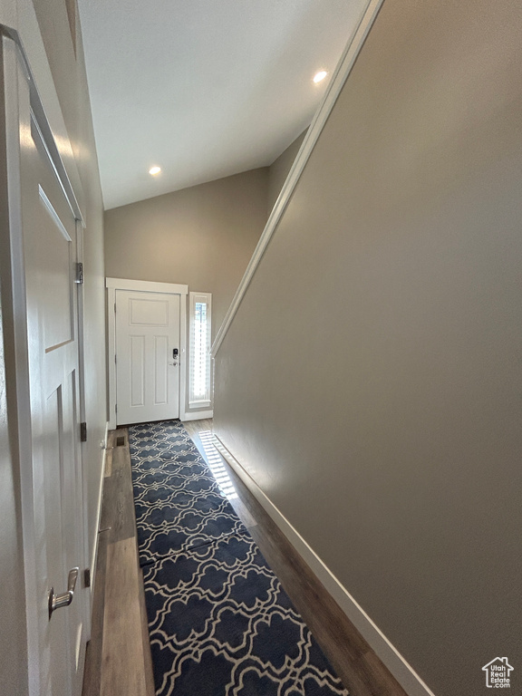 Entryway with dark wood-style flooring, baseboards, recessed lighting, and lofted ceiling