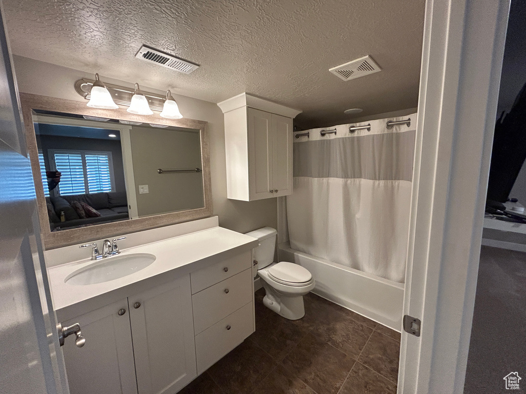 Ensuite bathroom featuring vanity, ensuite bathroom, toilet, and visible vents