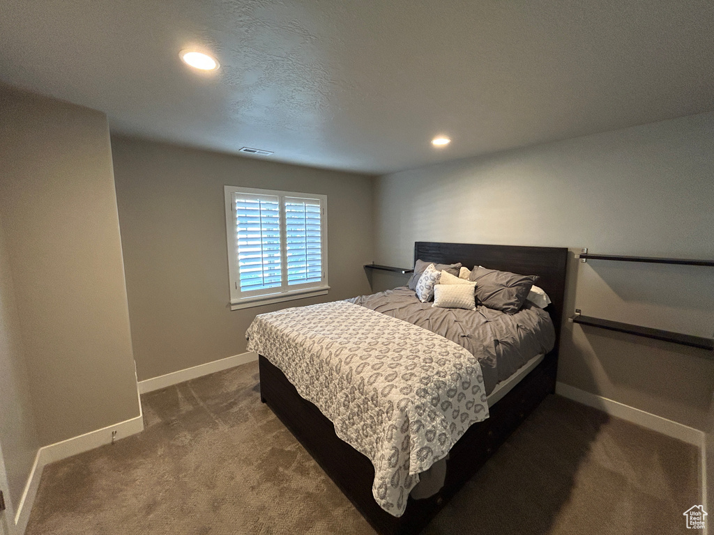 Bedroom featuring visible vents, recessed lighting, baseboards, and dark carpet