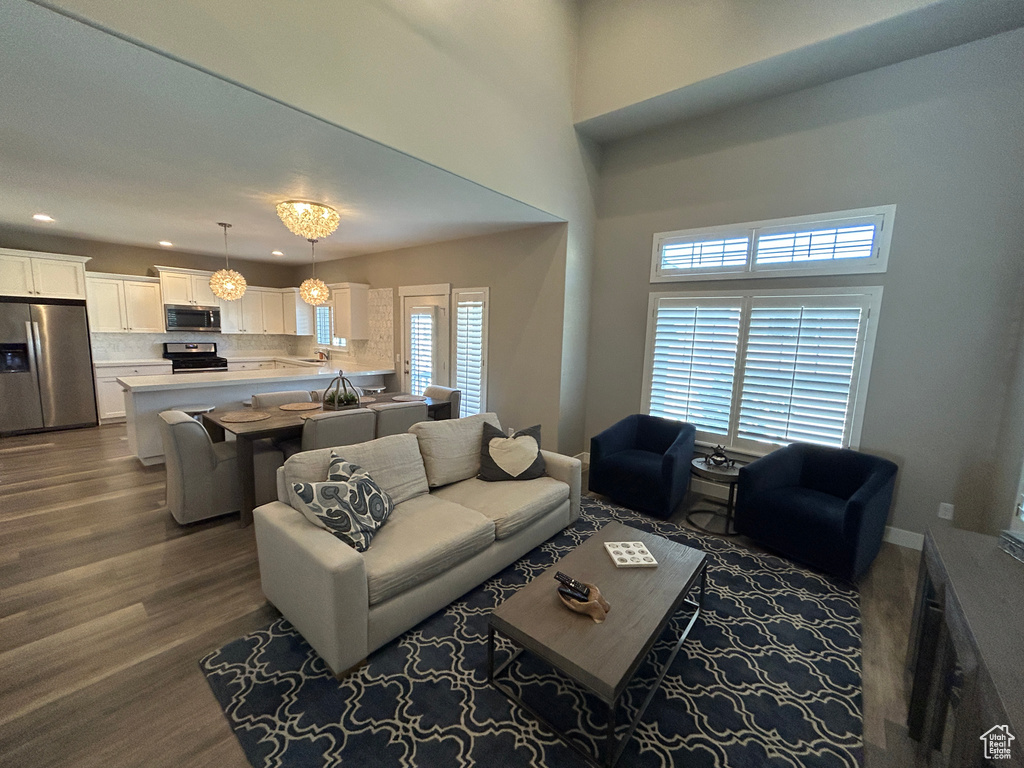 Living area featuring recessed lighting and dark wood-type flooring