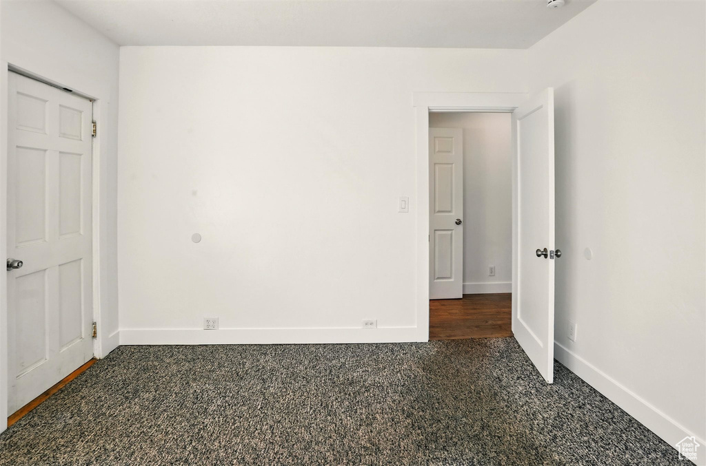 Carpeted empty room featuring baseboards
