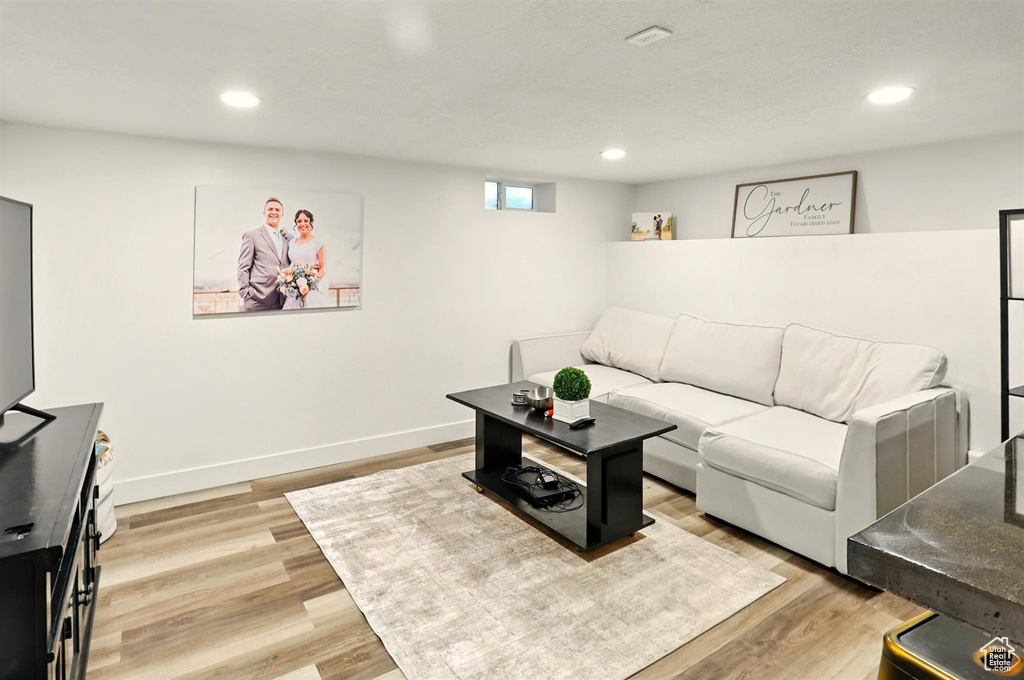 Living area featuring light wood-type flooring, recessed lighting, and baseboards
