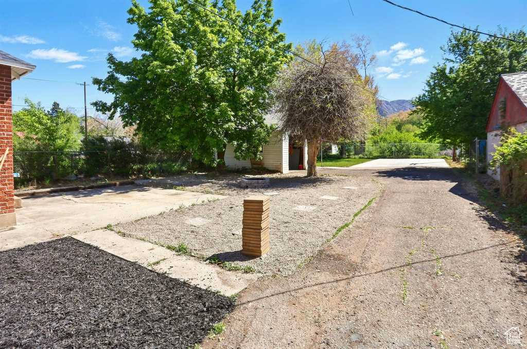 View of yard with fence and a mountain view