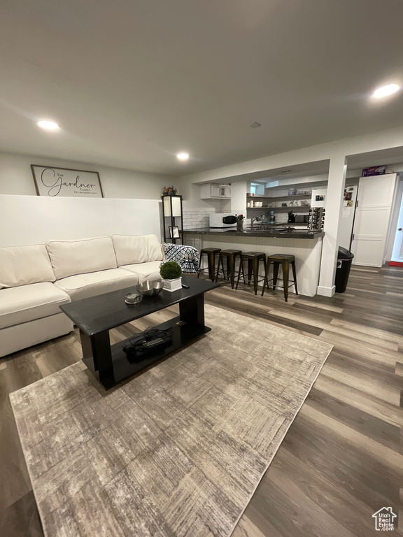 Living room featuring wood finished floors and recessed lighting
