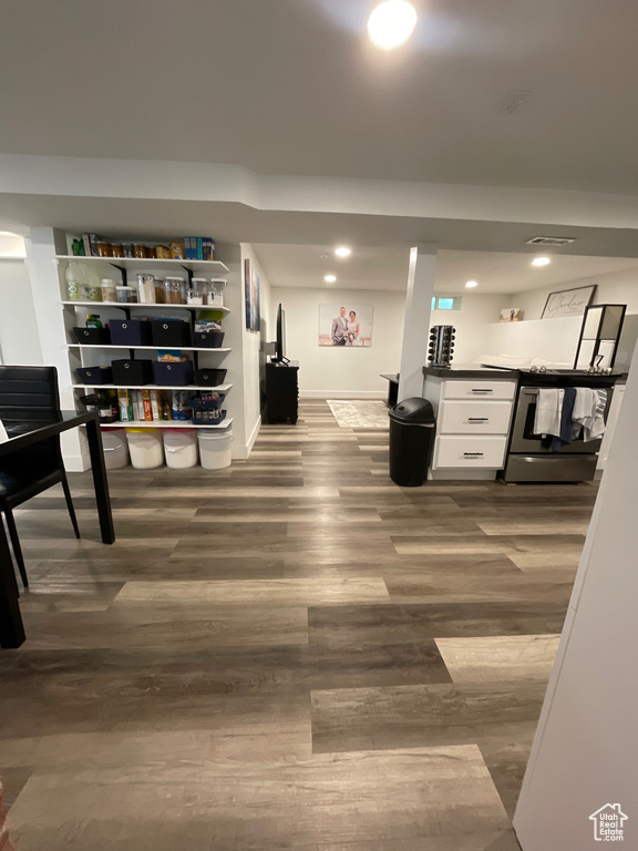 Interior space featuring baseboards, dark wood-type flooring, and recessed lighting