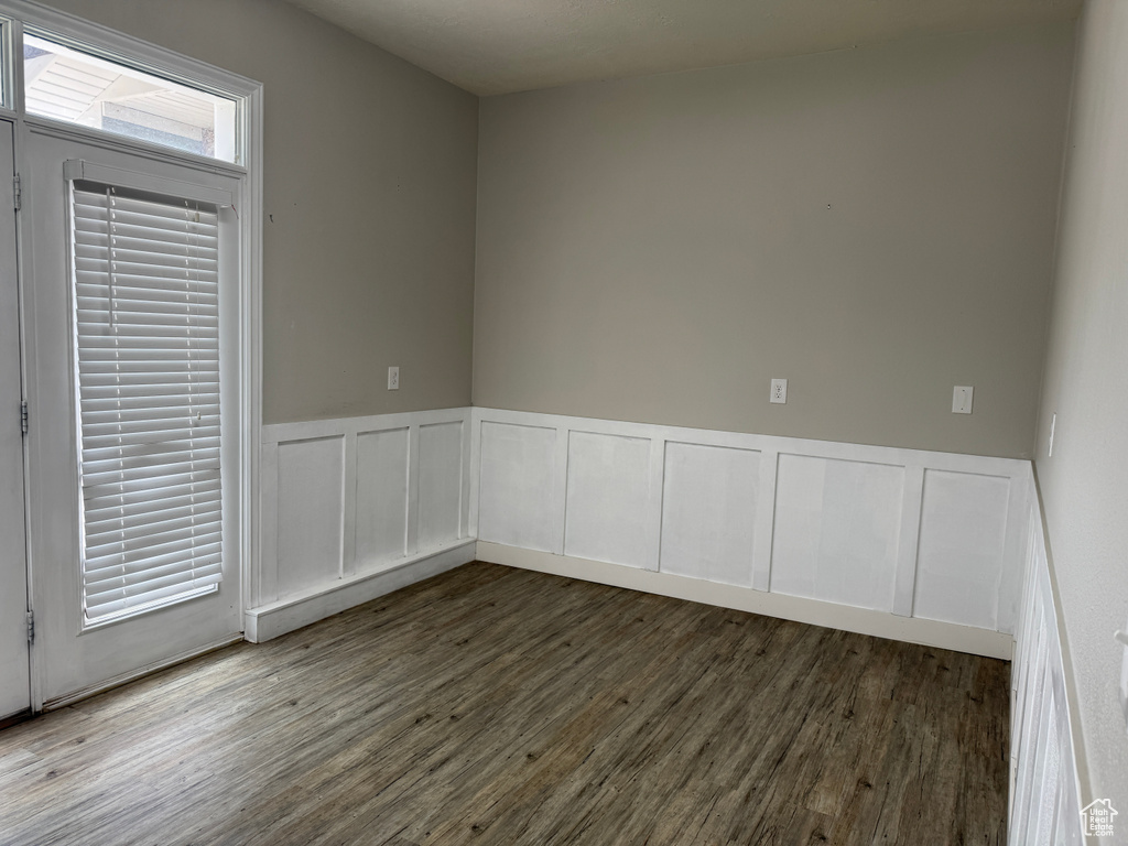Empty room with wood finished floors and wainscoting