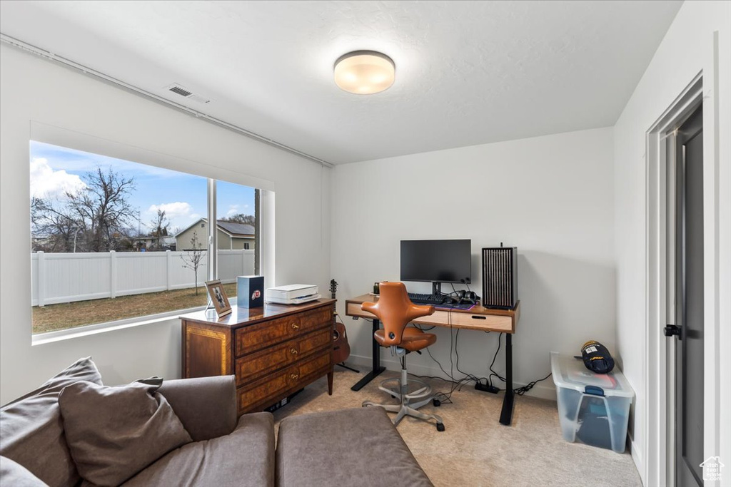 Carpeted home office featuring visible vents