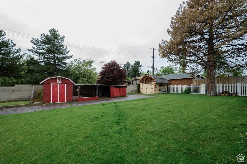 View of yard with a fenced backyard, an outdoor structure, and a shed