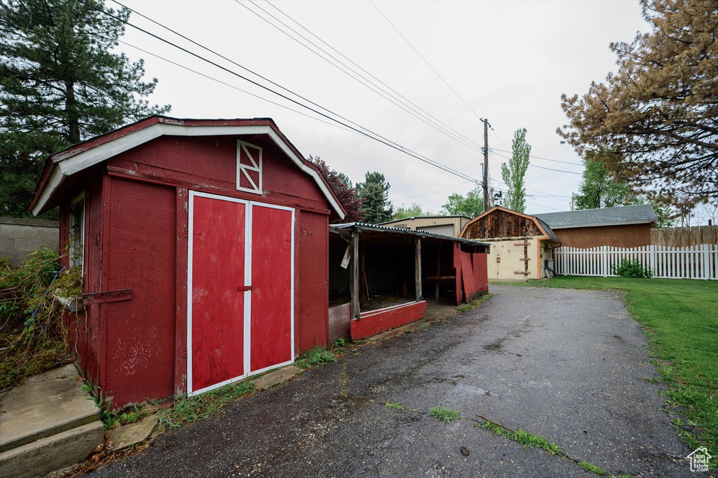 View of shed featuring fence