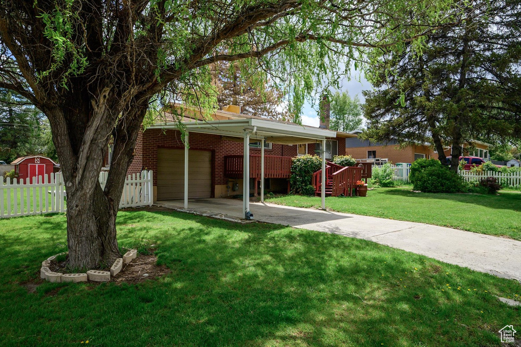 Ranch-style home with fence, a chimney, a front yard, and brick siding