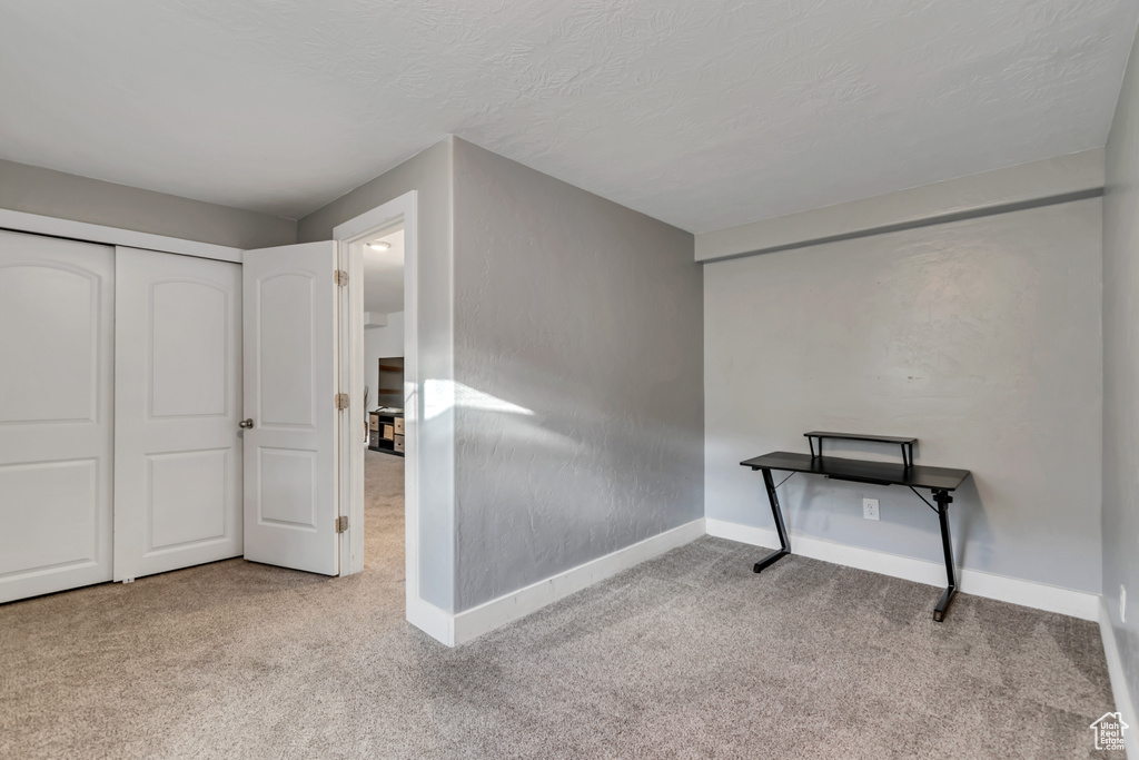 Interior space with baseboards and a textured ceiling