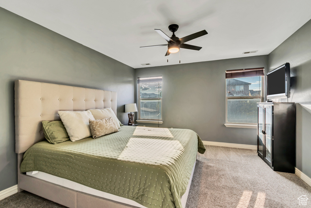 Bedroom featuring visible vents, carpet, baseboards, and a ceiling fan
