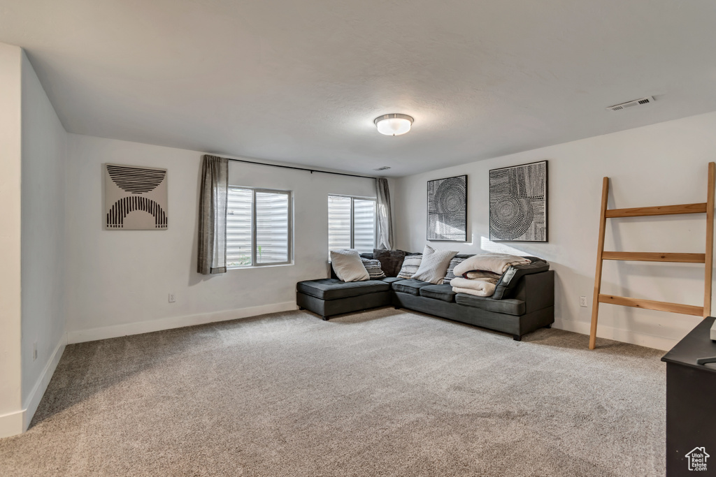 Living room featuring baseboards, carpet flooring, and visible vents