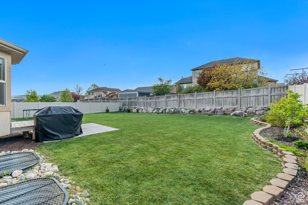 View of yard with a wooden deck and a fenced backyard