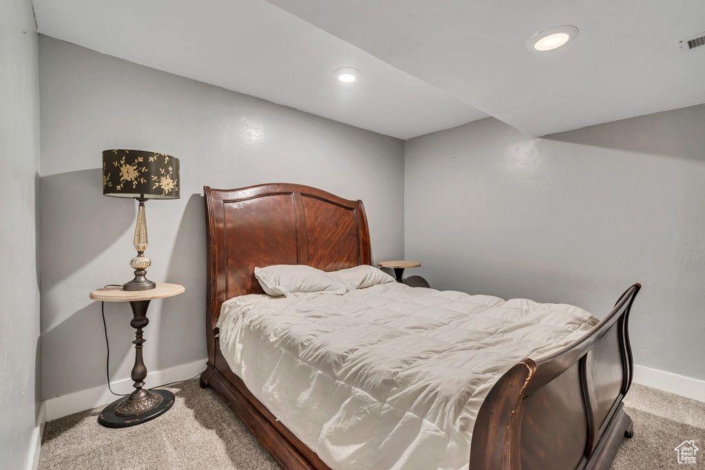 Carpeted bedroom with baseboards and recessed lighting