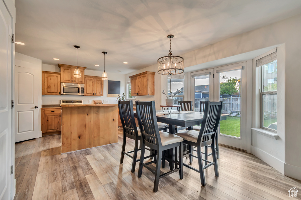 Dining room featuring recessed lighting, a notable chandelier, and light wood-type flooring