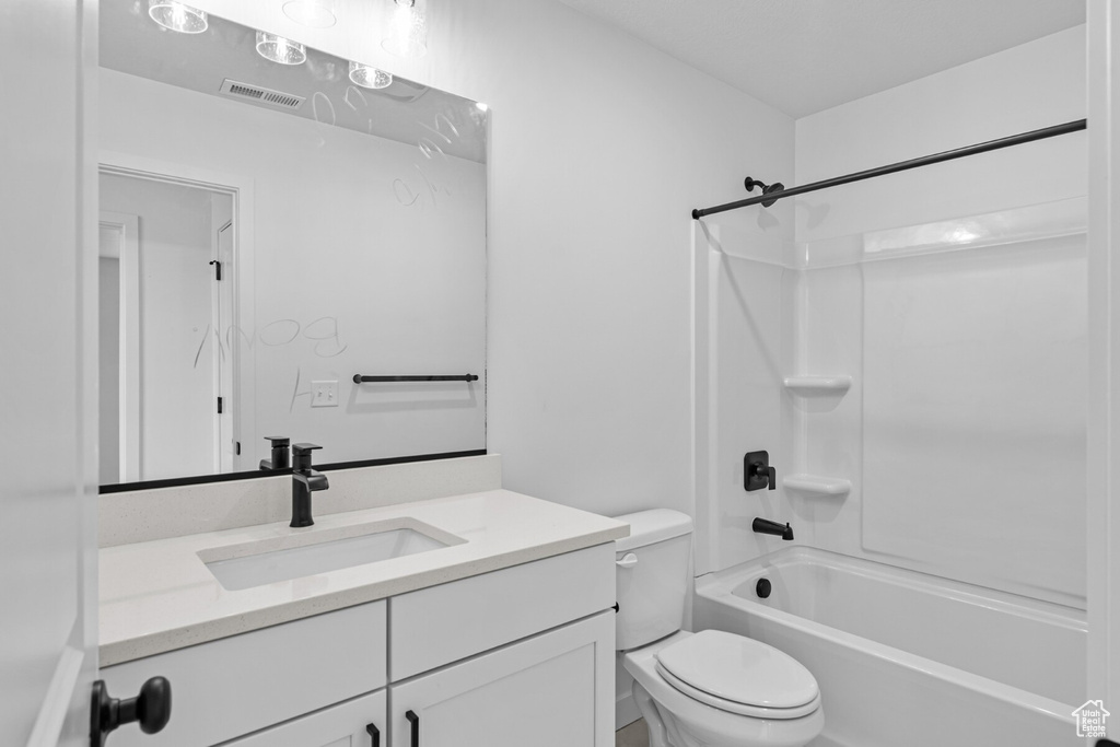 Full bath with visible vents, tub / shower combination, toilet, and vanity