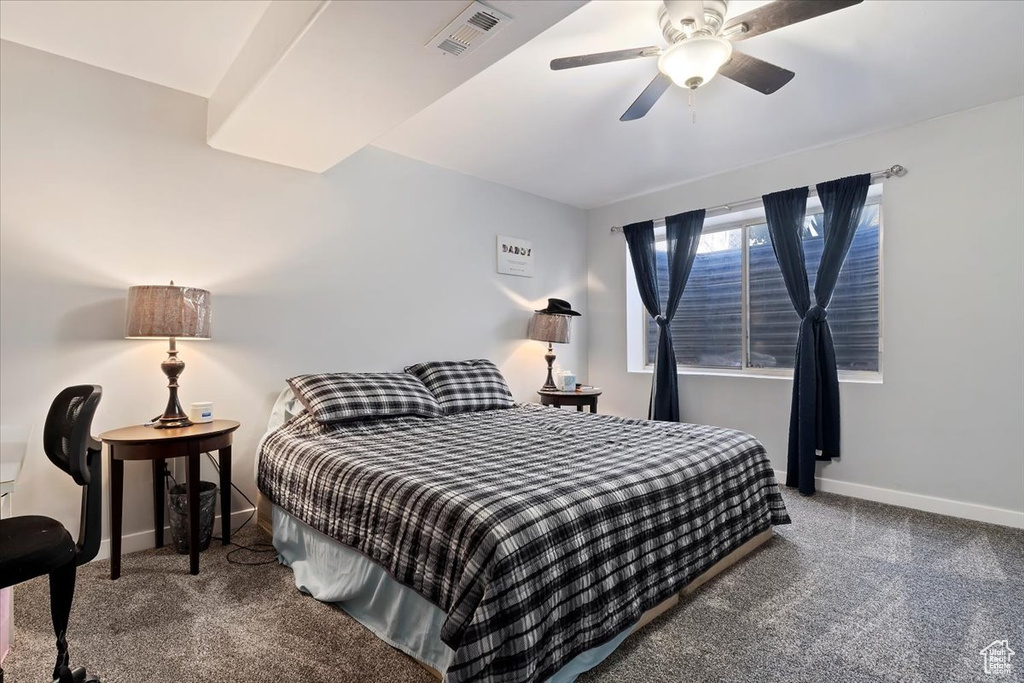 Carpeted bedroom featuring baseboards, ceiling fan, and visible vents