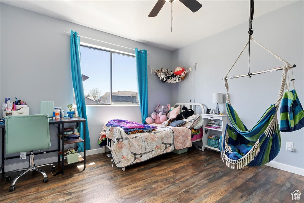 Bedroom featuring baseboards, ceiling fan, and wood finished floors