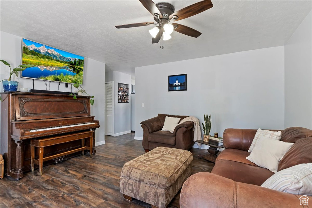 Living area with baseboards, a ceiling fan, and wood finished floors