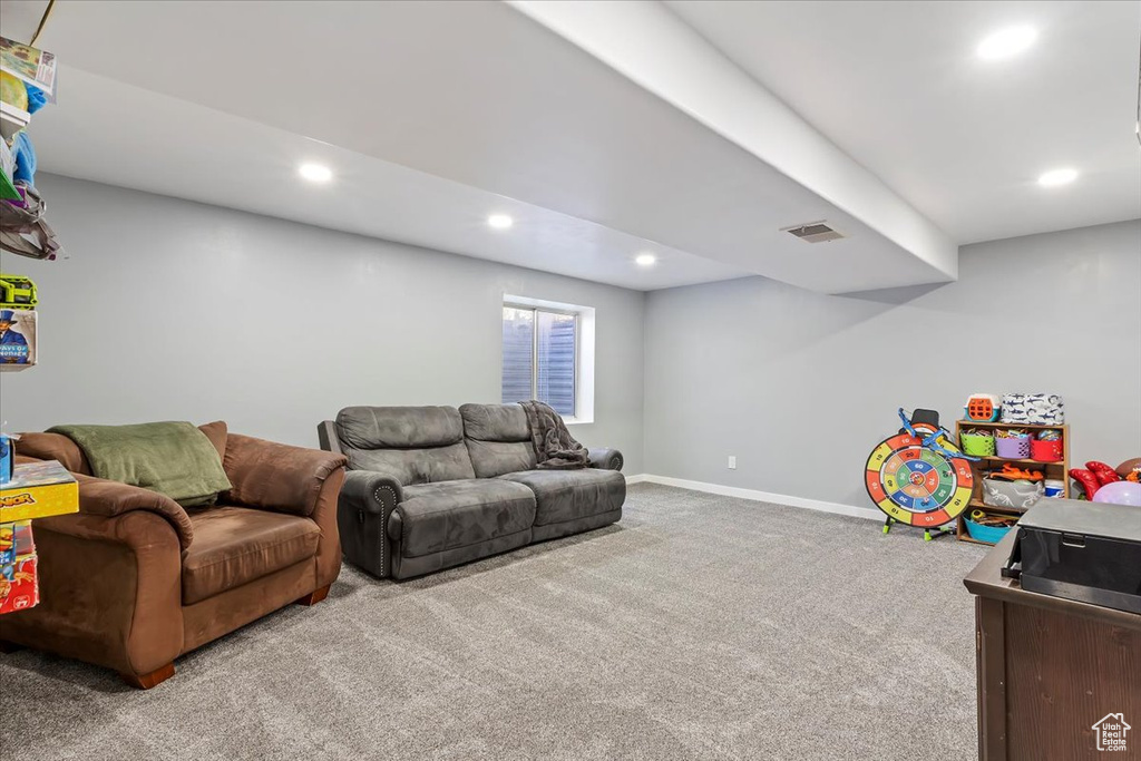 Carpeted living area featuring recessed lighting, baseboards, and visible vents