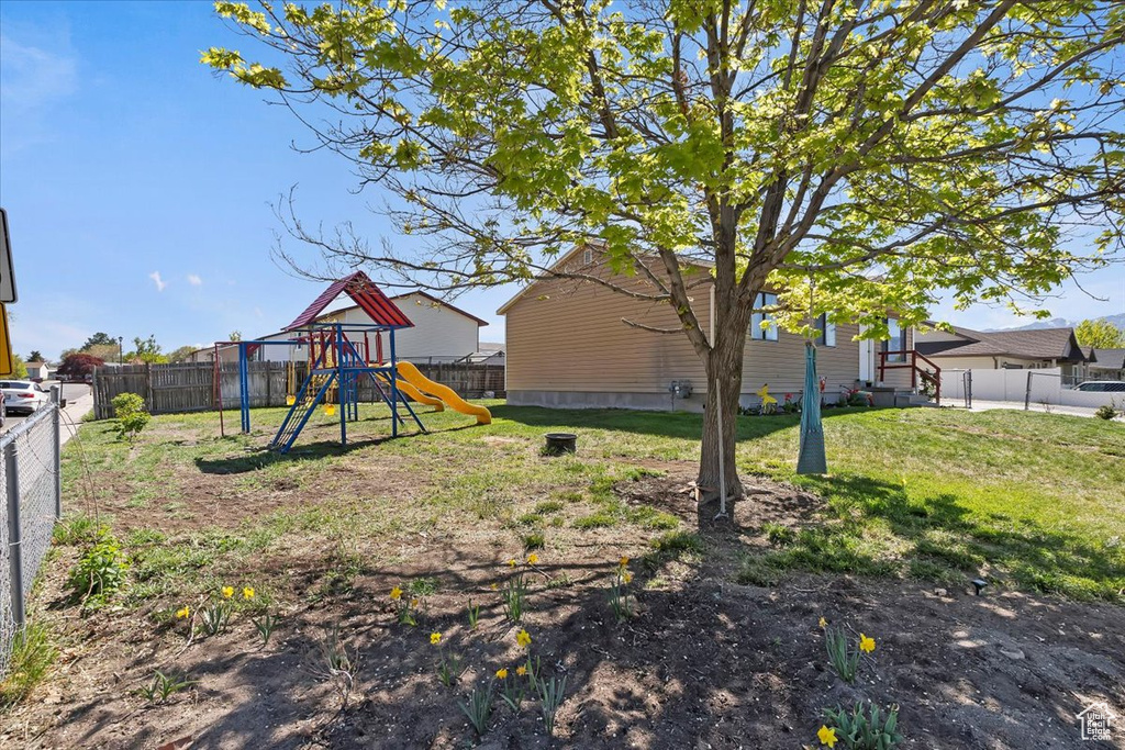 View of yard featuring a fenced backyard and a playground