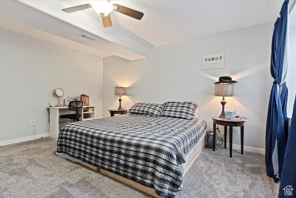 Carpeted bedroom featuring baseboards, ceiling fan, and visible vents