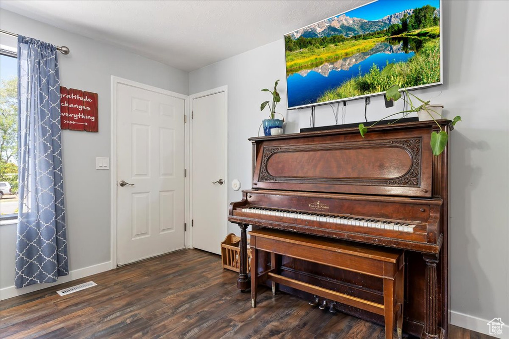 Sitting room featuring visible vents, dark wood finished floors, and baseboards