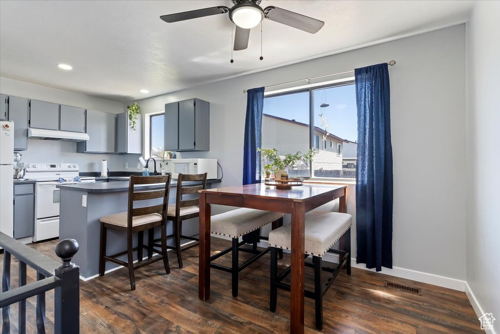 Dining space featuring ceiling fan, dark wood-type flooring, recessed lighting, and visible vents