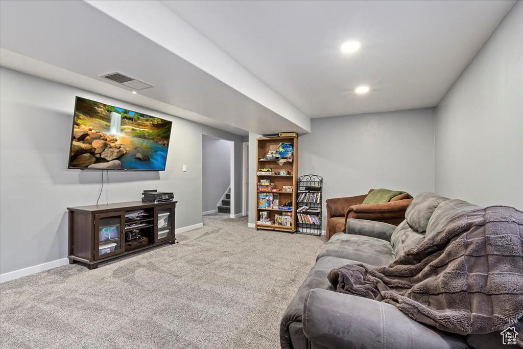 Living room featuring stairway, baseboards, carpet flooring, and visible vents