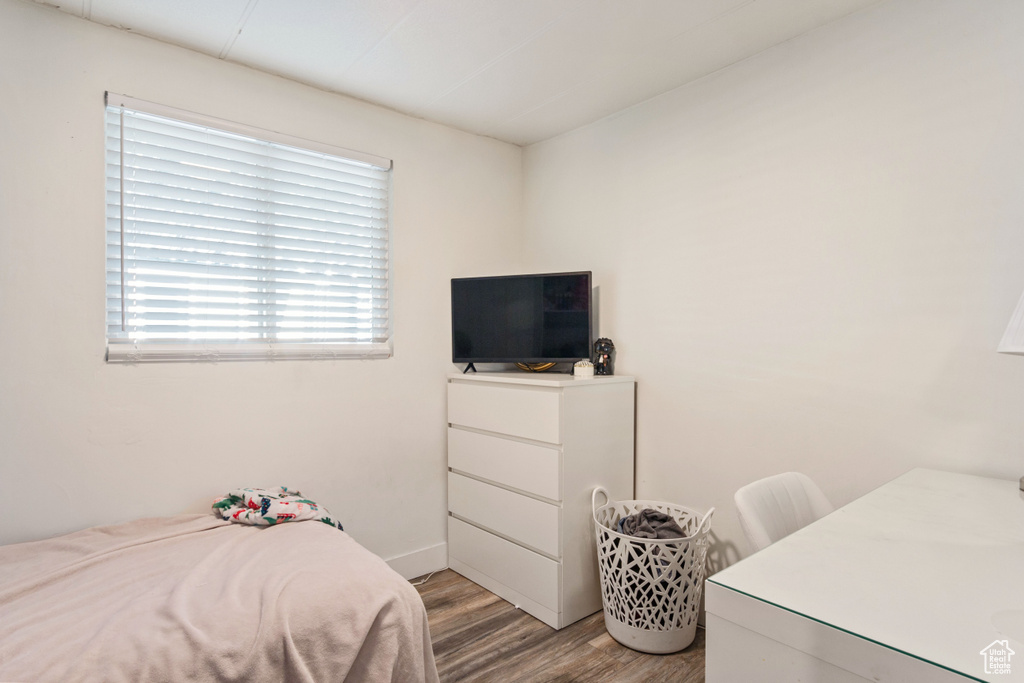 Bedroom with light wood-style floors and baseboards