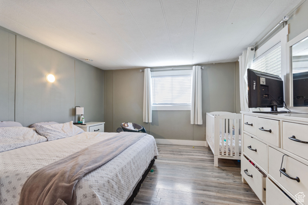 Bedroom featuring baseboards and wood finished floors