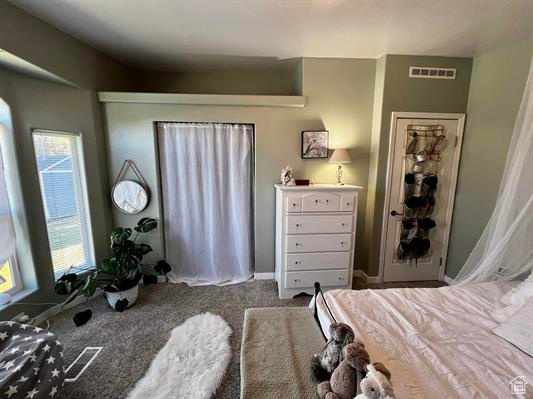 Carpeted bedroom featuring visible vents