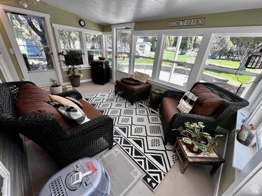Sunroom featuring a healthy amount of sunlight and lofted ceiling