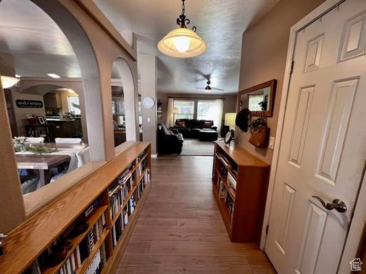Hall with wood-type flooring and arched walkways