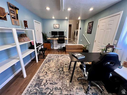 Office area featuring baseboards, recessed lighting, a textured ceiling, and wood finished floors