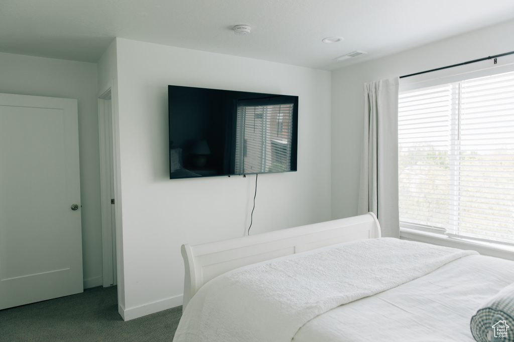 Carpeted bedroom with baseboards