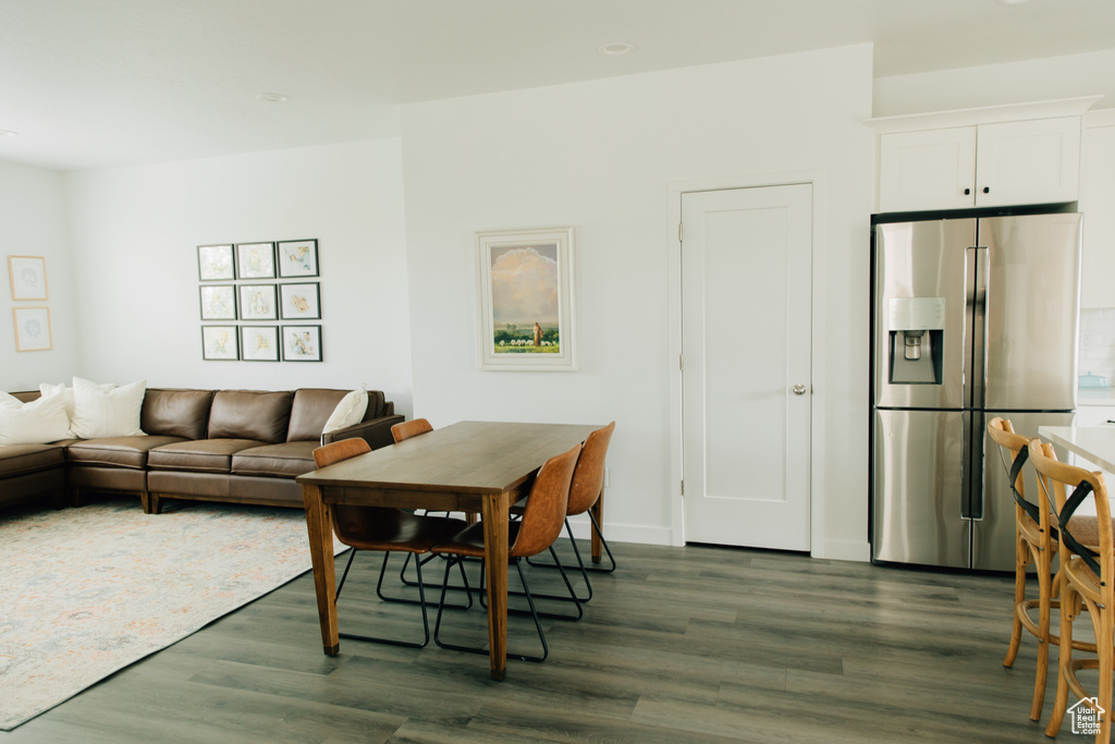 Living room featuring baseboards and dark wood-style flooring