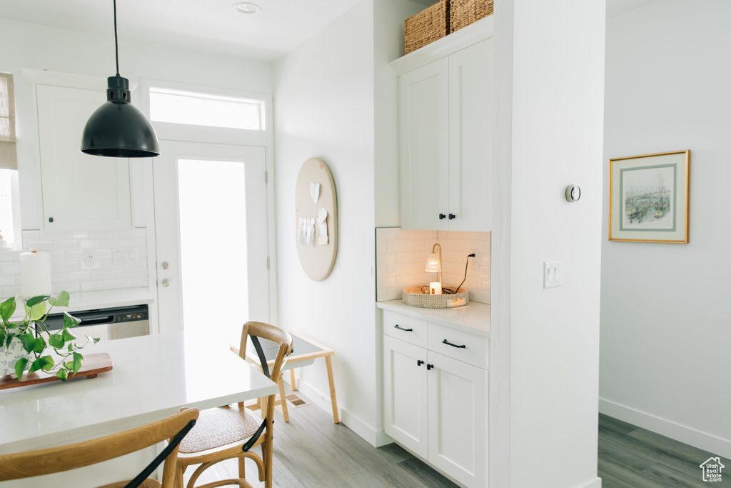 Interior space with baseboards and light wood-style floors