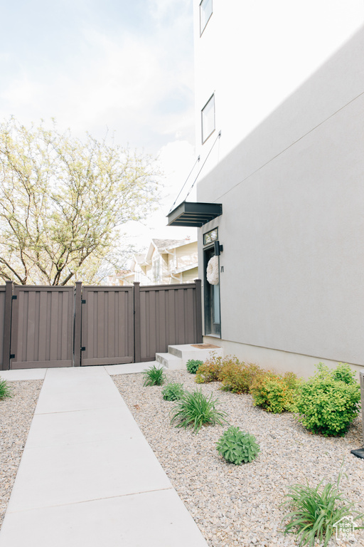View of home's exterior with fence, a gate, and stucco siding