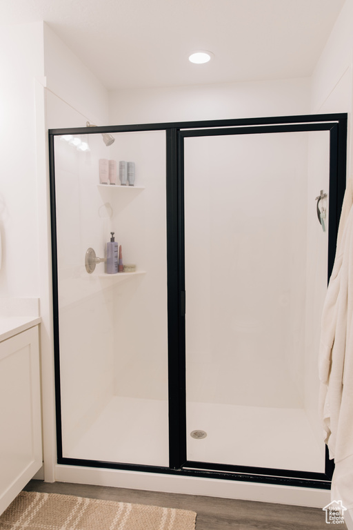 Bathroom featuring recessed lighting and a shower stall