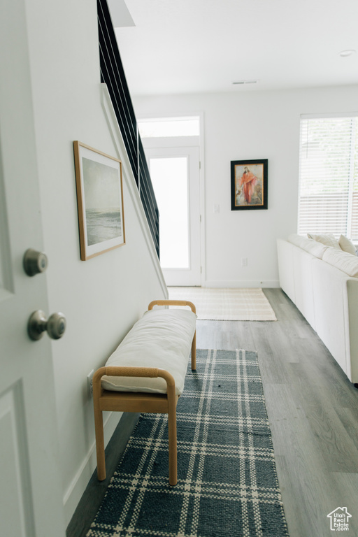 Foyer with baseboards, stairs, and wood finished floors