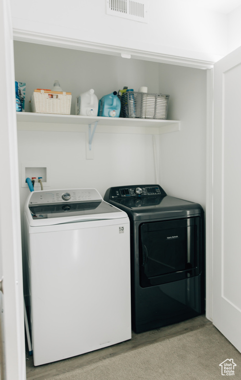 Laundry room with visible vents, laundry area, and washing machine and clothes dryer