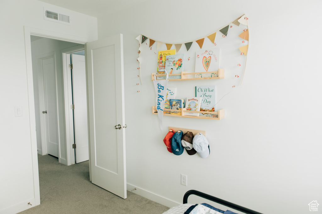 Bedroom with visible vents, carpet, and baseboards