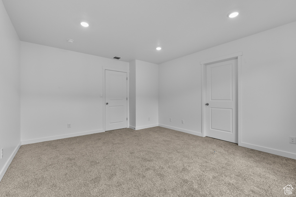 Carpeted spare room featuring recessed lighting and baseboards